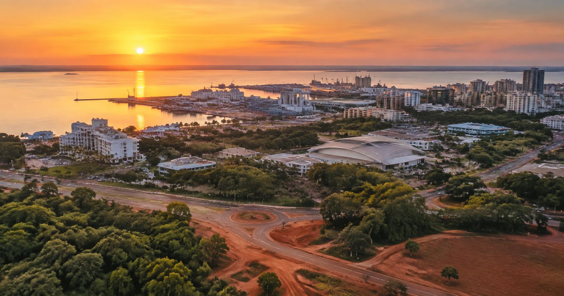Aerial view of Darwin and its harbour at sunset with low commercial buildings and red earth